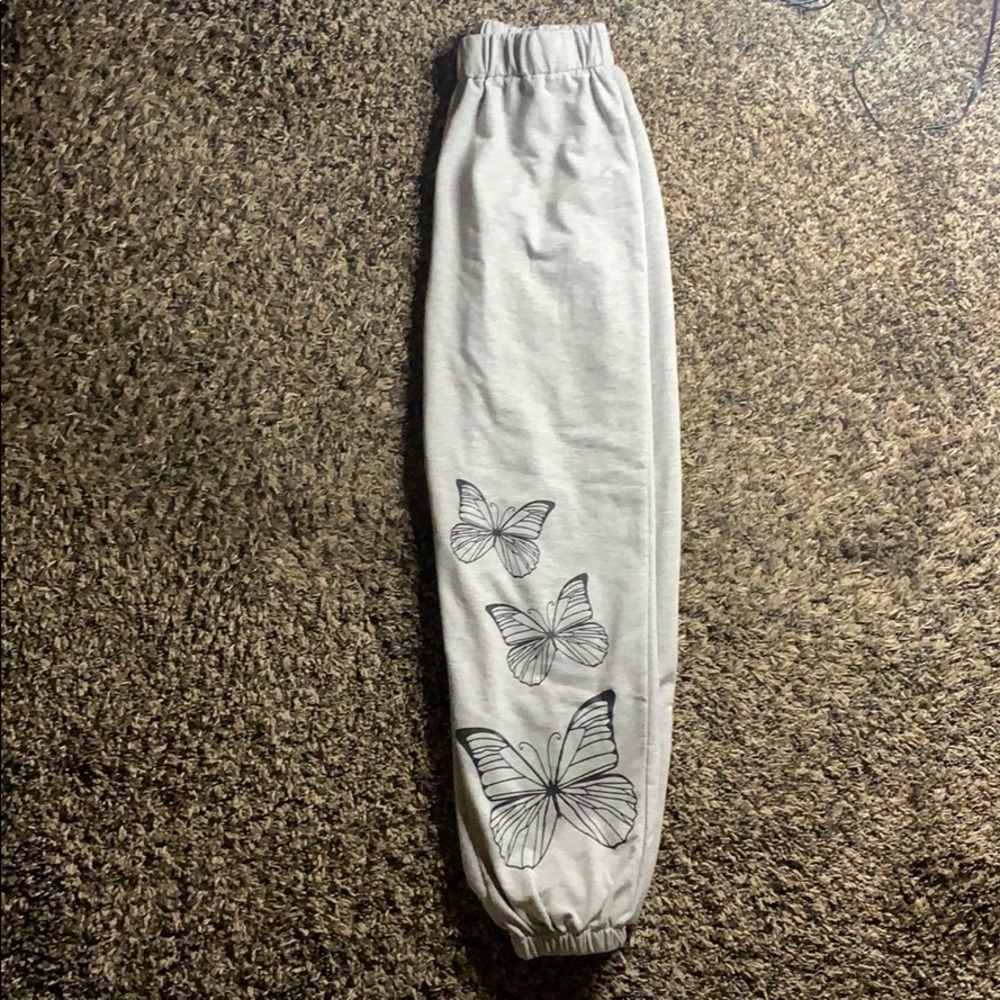 grey sweat pants with black butterflies